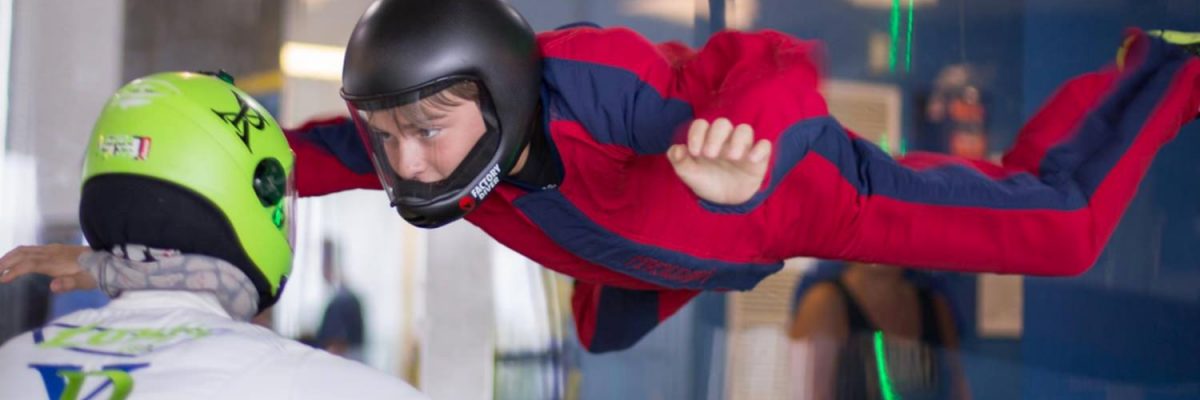 young boy learning how to indoor skydive