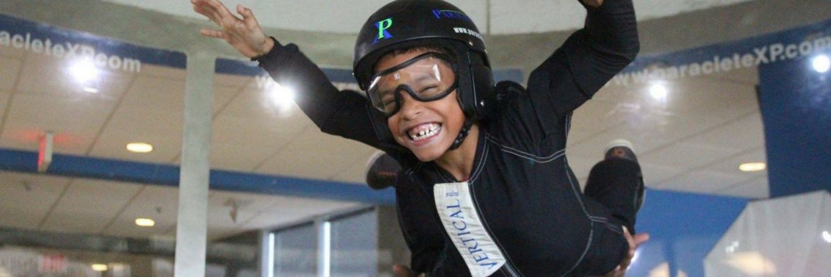 young kid flies in indoor skydiving wind tunnel