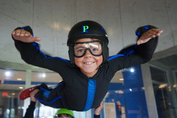young boy indoor skydiving