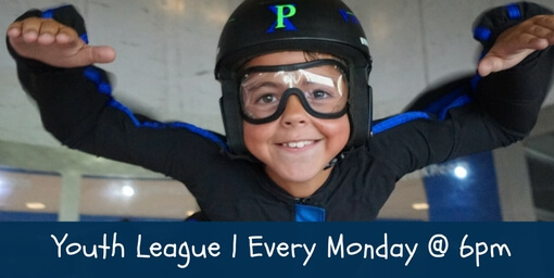 Young boy smiles while flying in the tunnel at the Paraclete XP youth league.