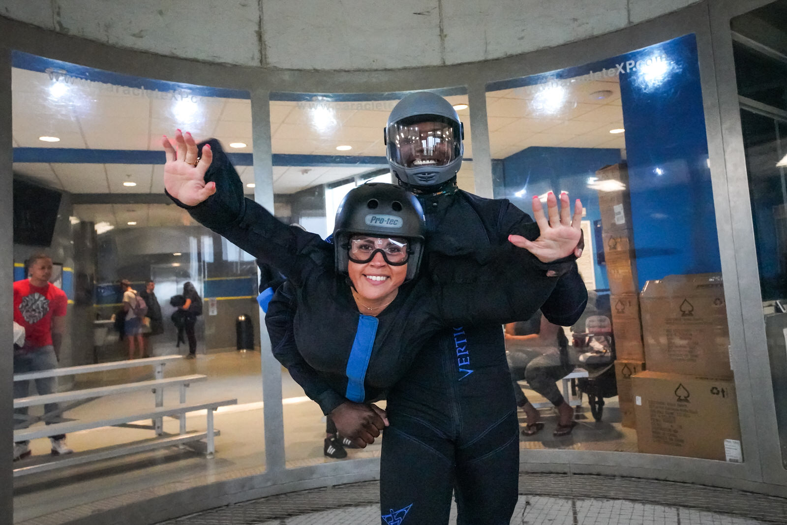 Wind tunnel instructor holds onto student 