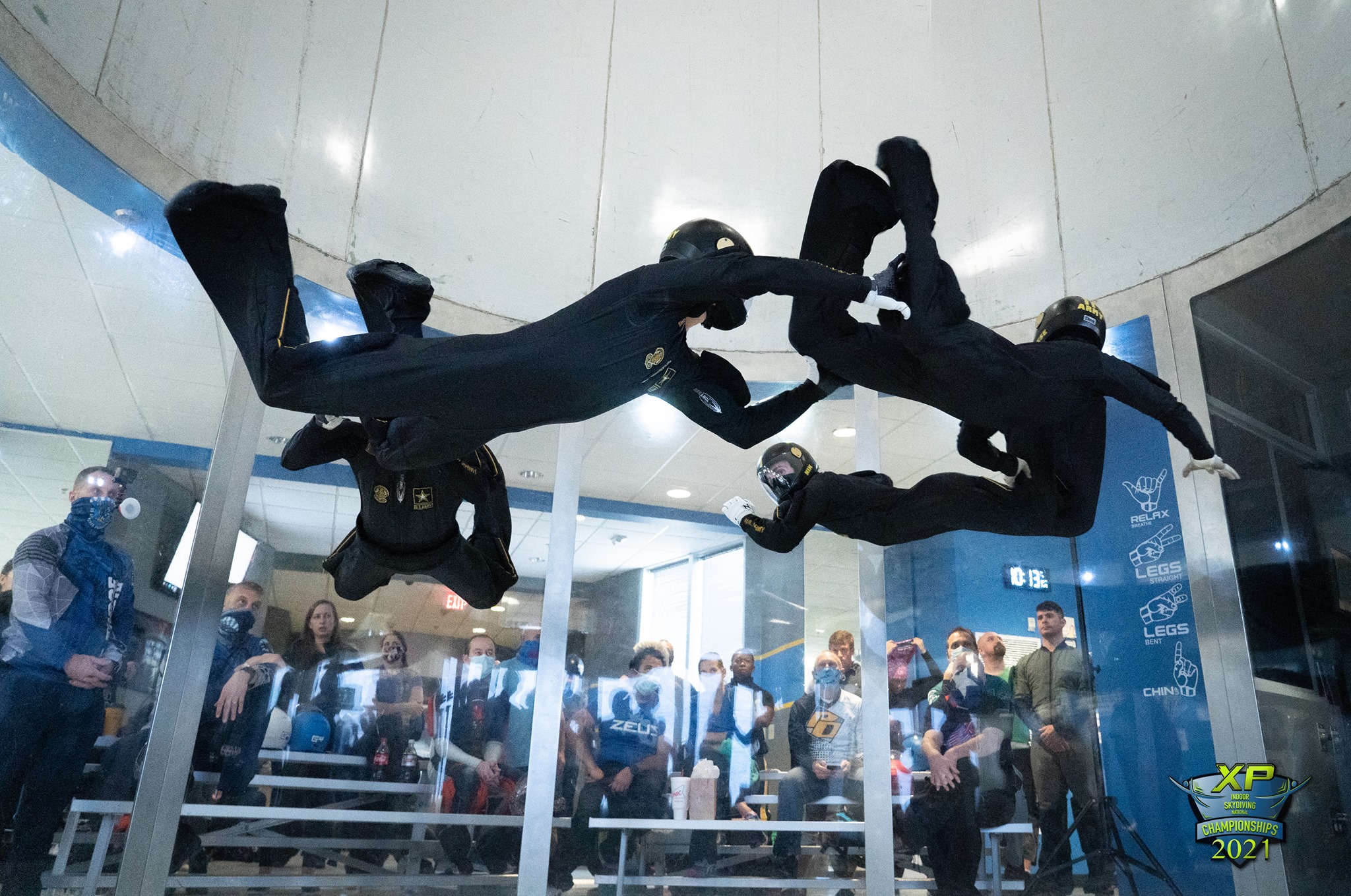group of indoor skydivers belly flying