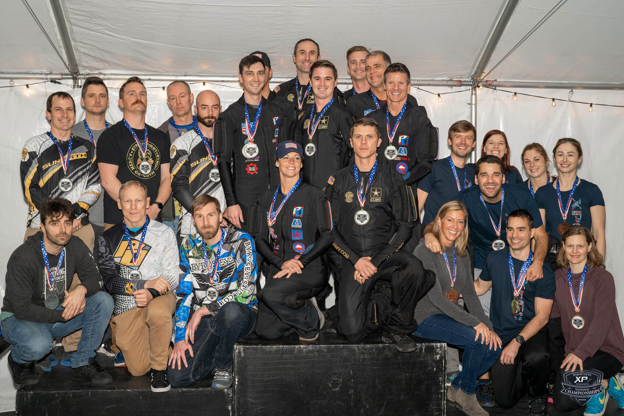 Champions adorned in medals at the 2023 Indoor Skydiving Nationals. 