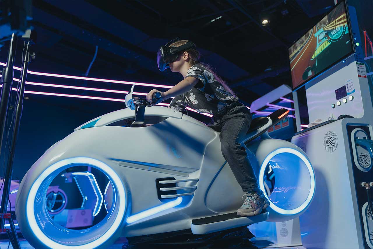 Girl rides bike at VR arcade