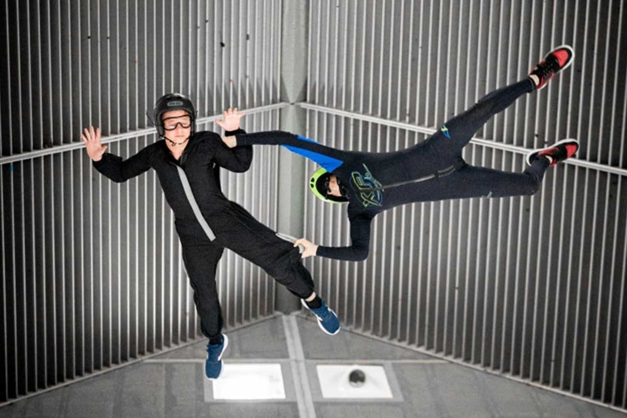 Indoor skydivers in the top of the tunnel