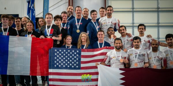 World indoor skydiving competitors on podium holding their nation's flags